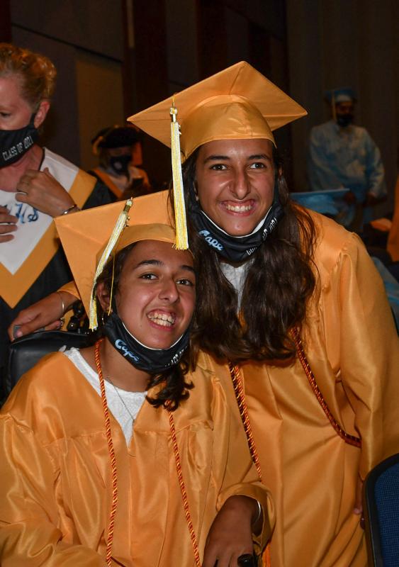 Twin sisters Annmarie, left, and Sara Perrotta await the processional.