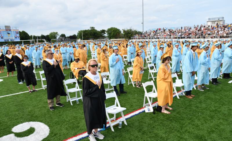 Over 400 students and staff stand for the salute to the flag.