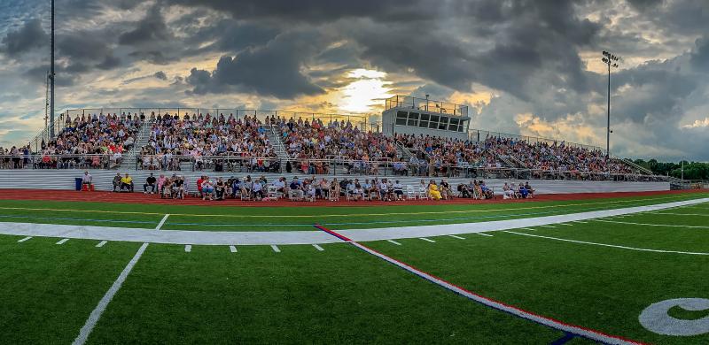 The sun breaks through the dark clouds at the Cape commencement.