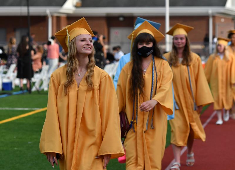 Grads Fallon Moore and Ashlyn Moore lead a group during the processional.
