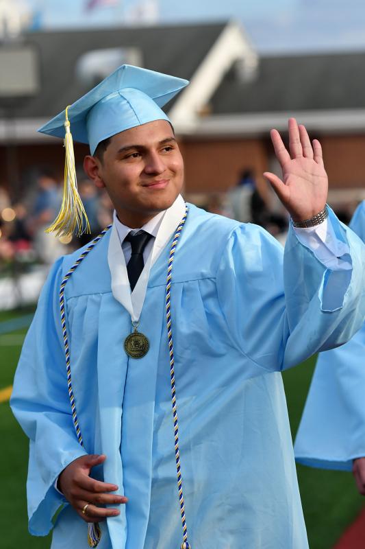 Gilberto Antonio Mejia-Lara waves to his family during the processional.