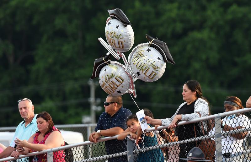 A family waits to spot their senior during the processional.