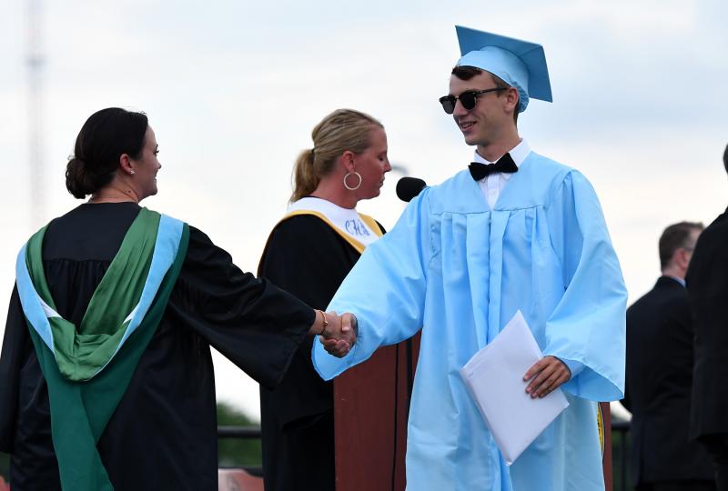 Jacob Alt receives congratulations from Principal Nikki Miller.