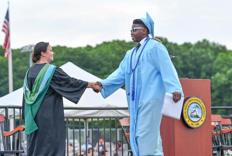 Ja’Vaughn Burton receives congratulations from Principal Nikki Miller.