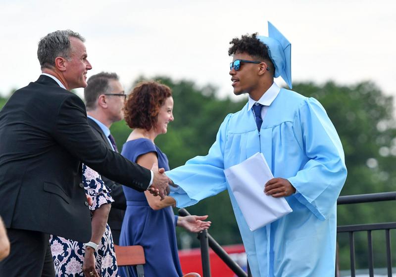 Jaden Davis receives congratulations from Superintendent Bob Fulton.