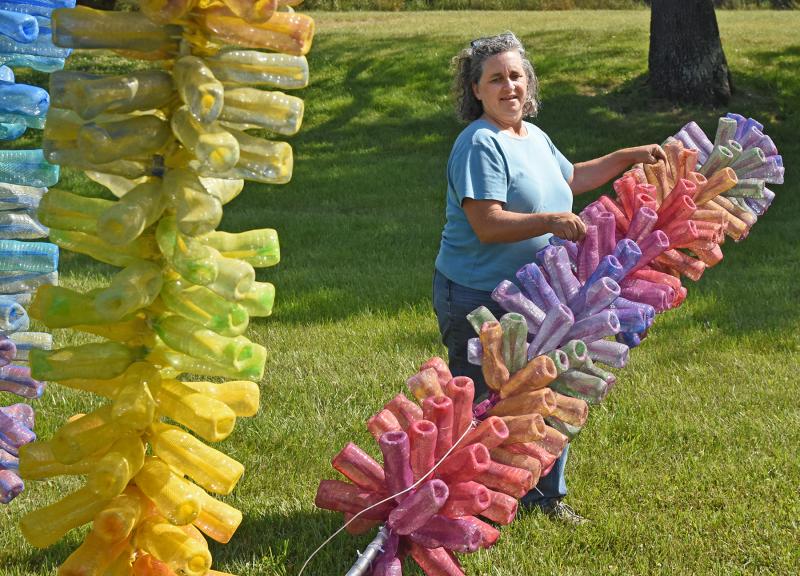 Artist Kate Dodd positions the stalks.