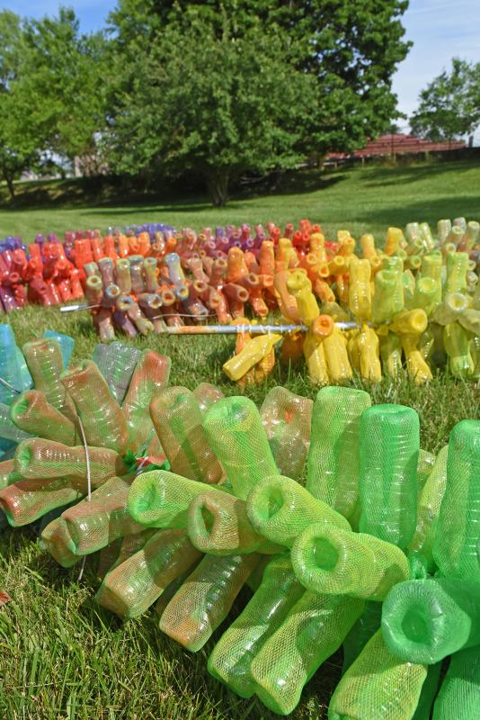 The stalks lie on the grass before they’re erected.
