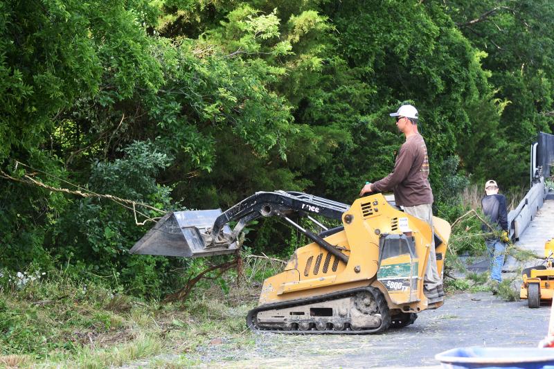 Mike Schimmel takes charge of the heavy machinery to speed up the process. NICK ROTH PHOTOS