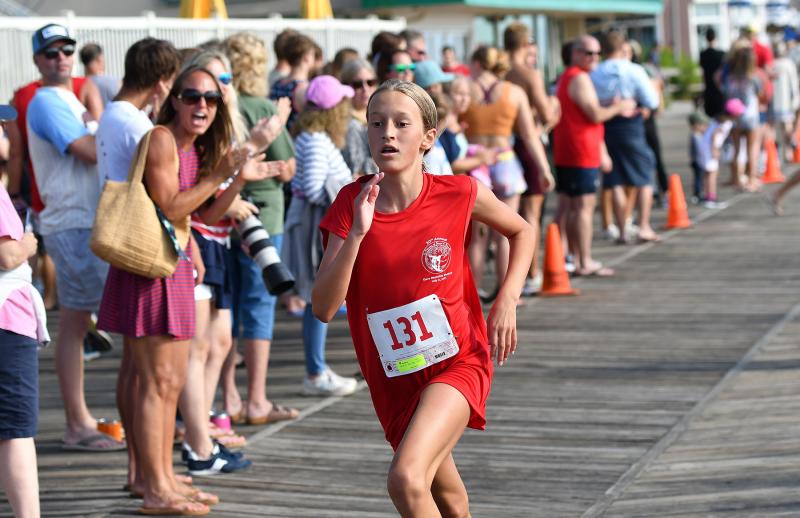 Anna Bockius, 13, of Wilmington sprints to first in her age group.