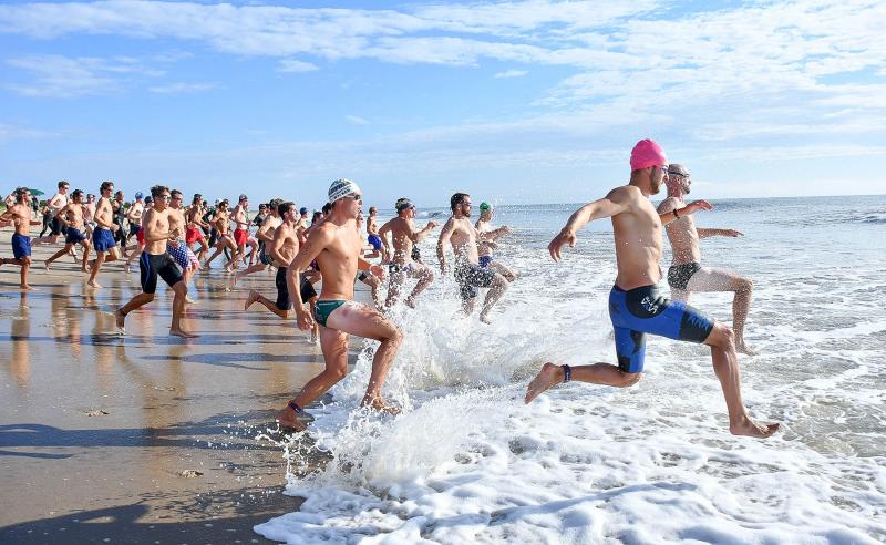 Participants take to the ocean to start the Dave Reynolds Biathlon July 4 in Rehoboth. DAN COOK PHOTOS