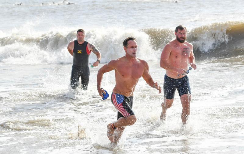 Swimmers sprint out of the Atlantic.