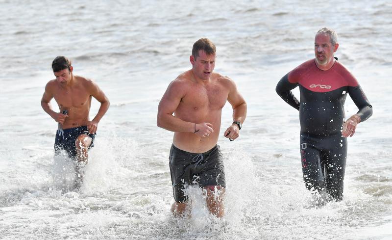 Swimmers exit the Atlantic on the way to the transition area.