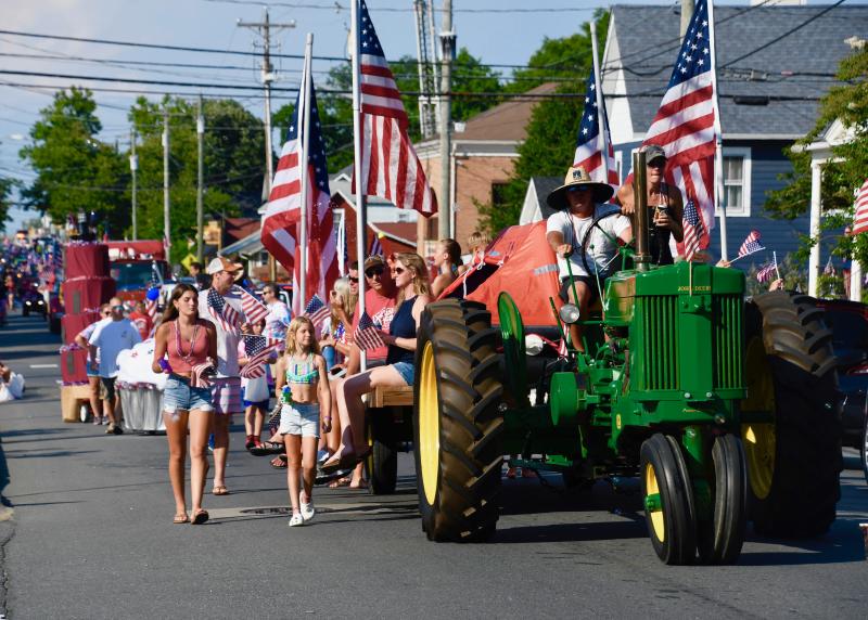 Tractors and flags line Savannah Road during the 2021 Doo-Dah Parade.