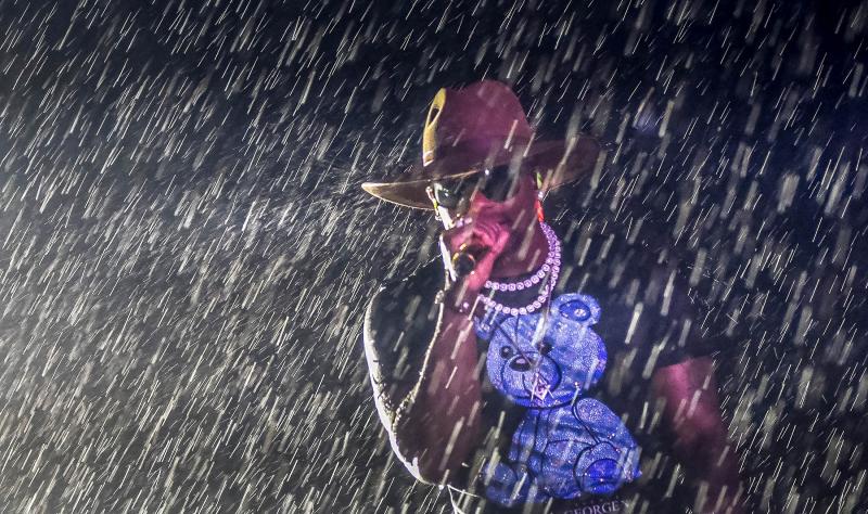 Jimmie Allen performs in the downpour.