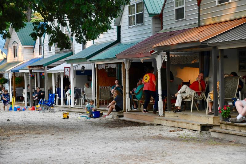 Many camp-goers listen to the services from their cabins surrounding the tabernacle.