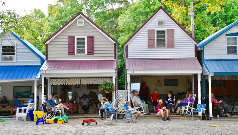 The wooden cabins have kitchens in the front and a sleeping area on the second floor.