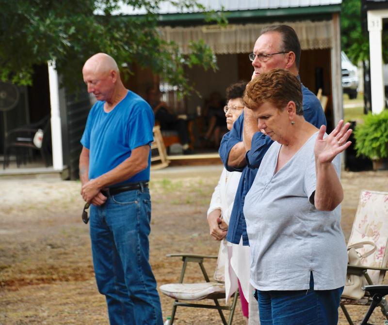 Another night of services gets underway with an opening prayer.