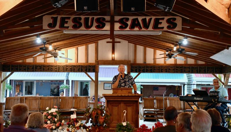 Worship leader Dale Dukes takes the pulpit Aug. 8 to start the last night of Carey’s Camp meeting. The camp near Millsboro has hosted evangelical services since 1888. RON MACARTHUR PHOTOS