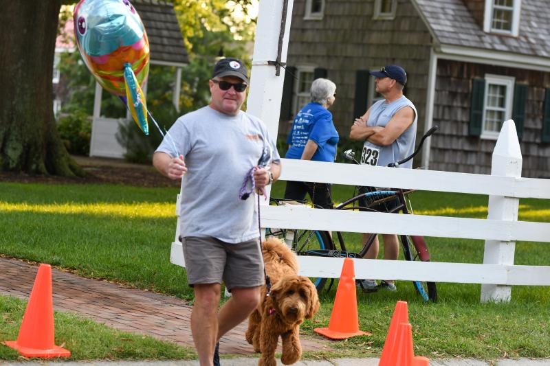 Kurt Saeger walks his Australian labradoodle while letting his fish flag fly.