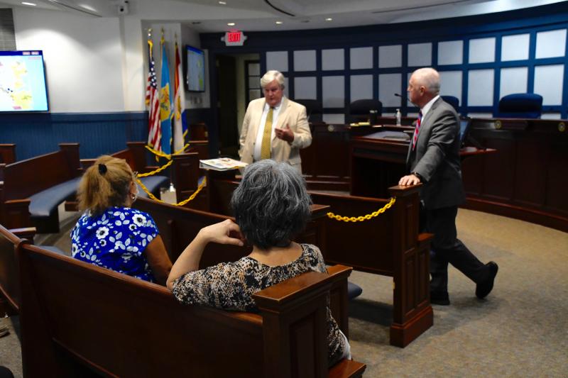Sussex County Council members John Rieley, left, and Doug Hudson meet with some residents during the protest to listen to their concerns and answer questions.