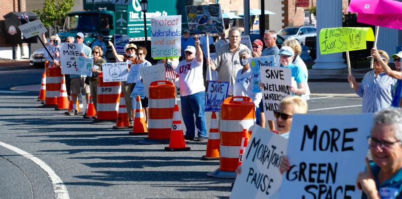 Protesters urge motorists to honk their horns as they drive around The Circle.