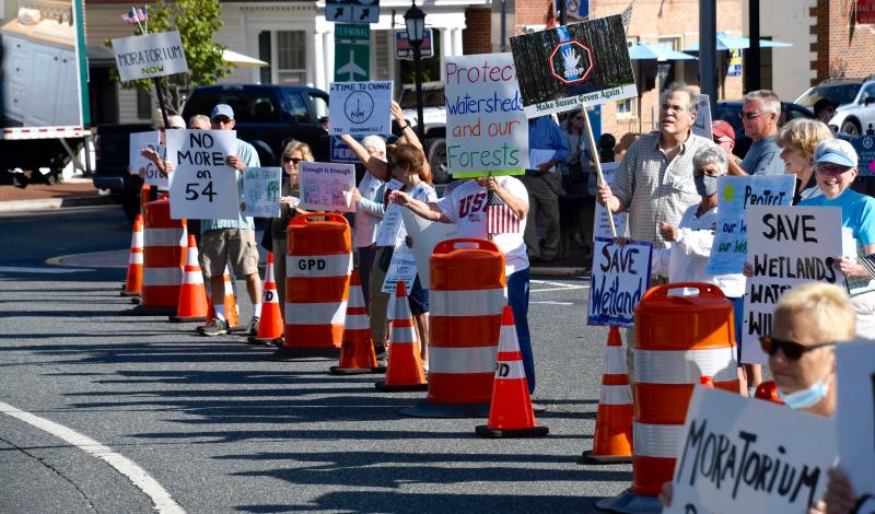 Some of the more than 150 protesters wave their signs Sept. 21 at passersby riding around The Circle in downtown Georgetown. Residents are upset about the pace of growth in the county, especially in eastern Sussex. RON MACARTHUR PHOTOS