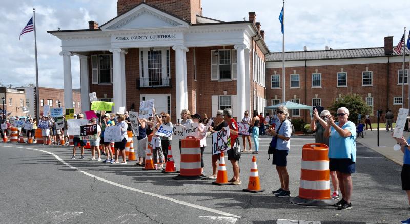 A large crowd gathers behind barricades placed on The Circle.