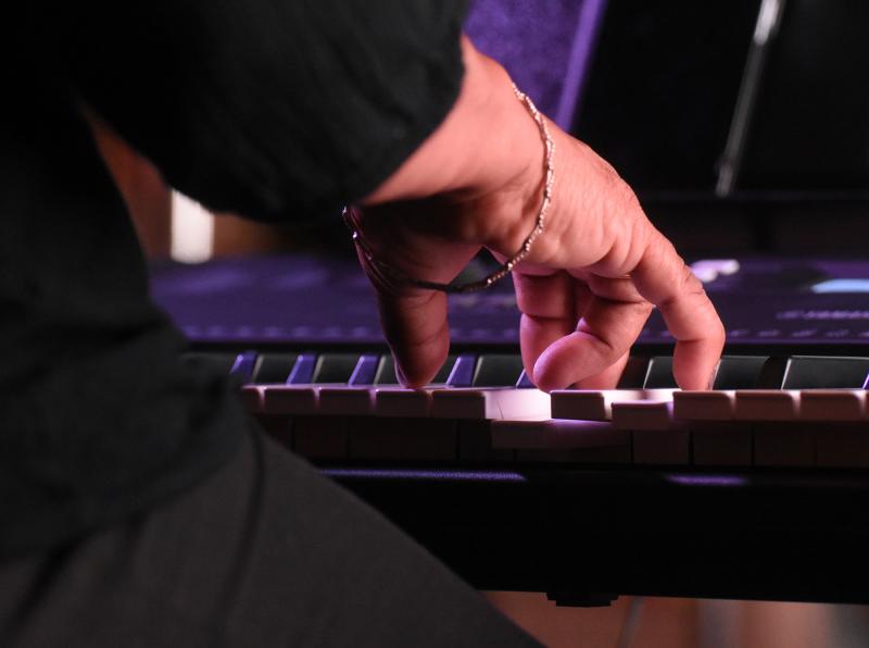 Music director Christy Taylor tickles the ivories as she plays with her students.