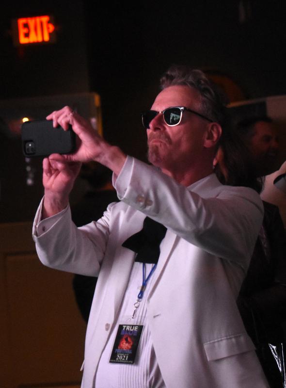 True Blue Jazz Festival organizer Eddie Sherman takes a photo of 12-year-old Alec Villar.