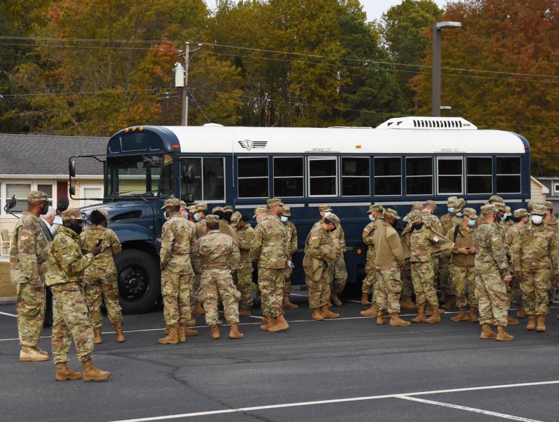 Soldiers gather at the buses before heading back to the Reserve Center in Lewes. NICK ROTH PHOTO