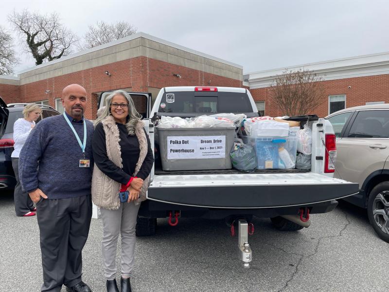 Craig Warrington, homeless liaison for the Cape Henlopen School District, left, and Nilima Palekar, chair of the Polka Dot Powerhouse Lewes Dream Drive, stand beside one of the three loads of personal hygiene items collected. SUBMITTED PHOTO