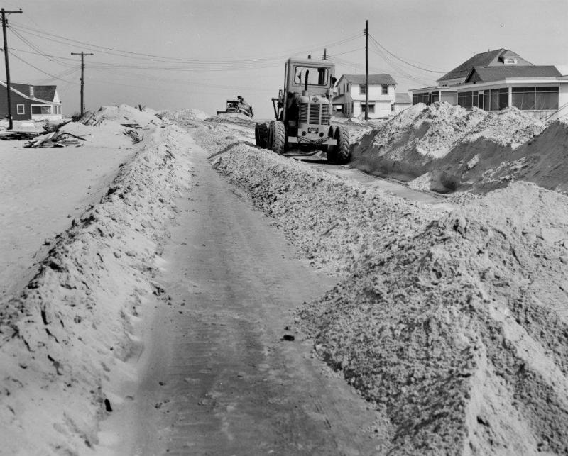 Sand, resembling drifting snow, is removed to clear a path to get into Dewey Beach. DELAWARE PUBLIC ARCHIVES PHOTO