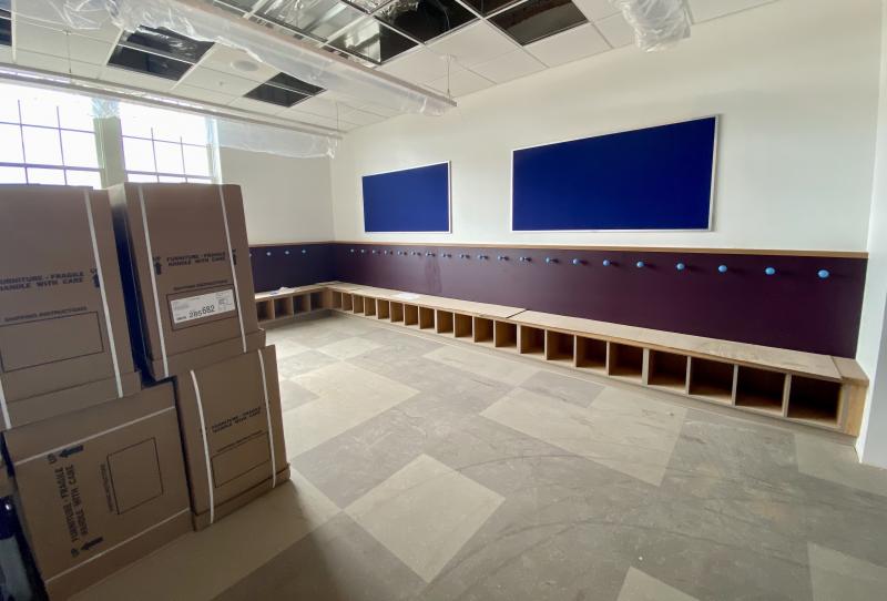 Furniture is ready to be assembled in this classroom.