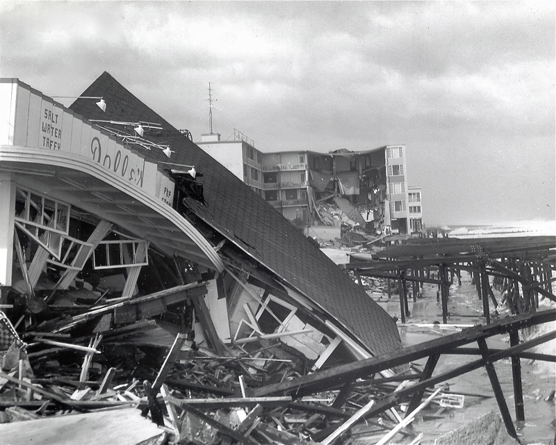 Dolle’s in Rehoboth Beach has collapsed into the sand amid the ruins of the Boardwalk. The damaged Atlantic Sands Hotel is in the background. DELDOT PHOTO