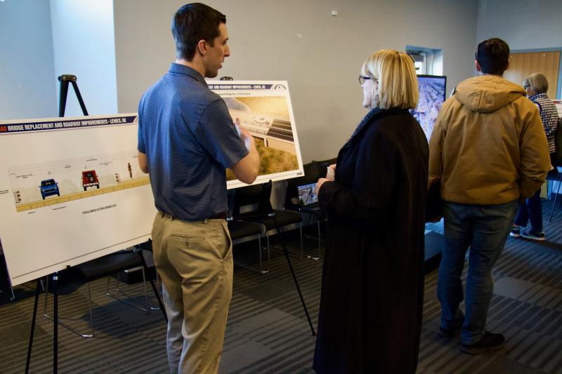 A Whitman, Requardt and Associates representative discusses the improvements and layouts of the new bridge with a concerned resident.