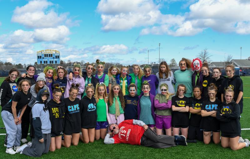 Batwomen and Jokers come together after a hard-fought game won by the Caped Crusaders.