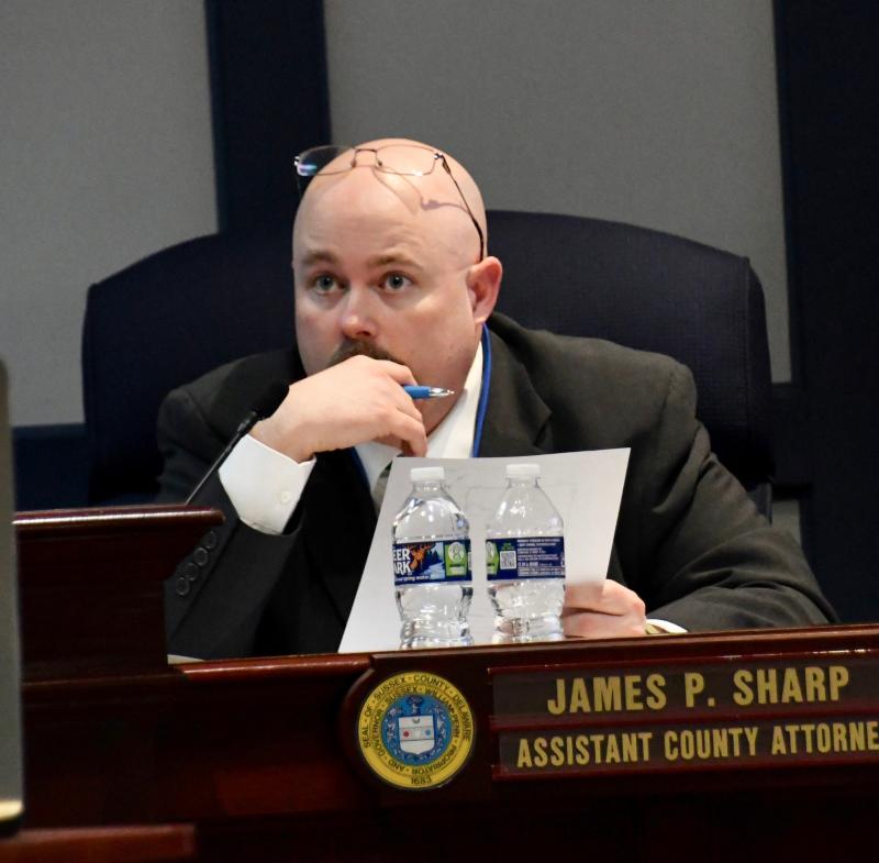 Board of adjustment attorney Jamie Sharp listens intently to the request for three variances to construct a fence around the Bidens’ North Shores home. RON MACARTHUR PHOTO