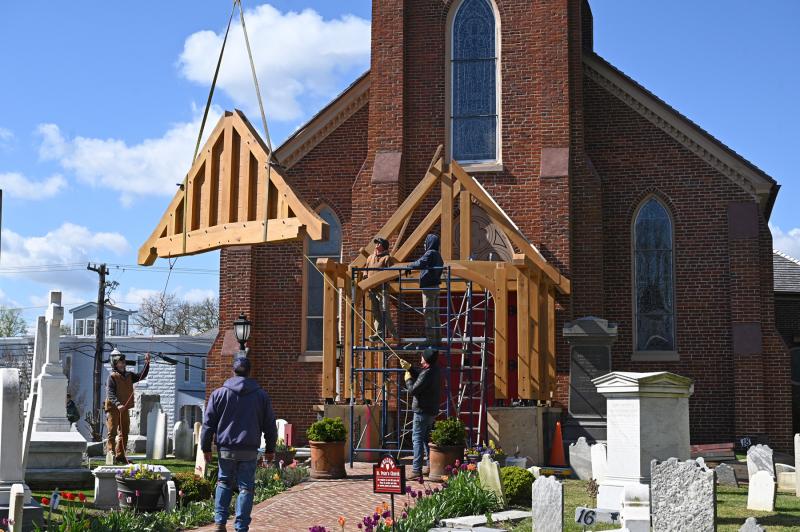 Crews use a crane to move pieces of the new portico into place at St. Peter’s Church in Lewes. NICK ROTH PHOTOS