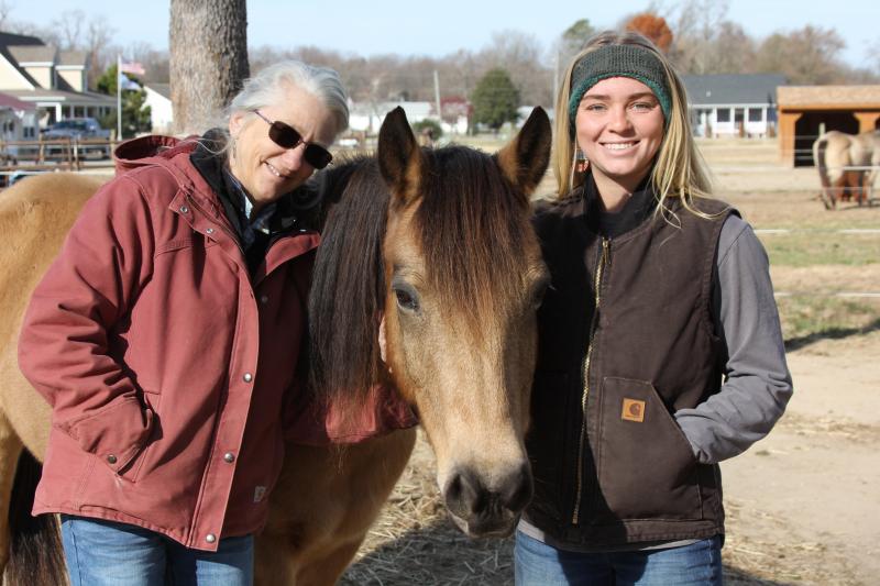 Rosemary Baughman, left, and Rebekah Baughman provide equine therapy services at Courageous Hearts. Seth, one of the farm’s seven equine therapy horses, perfectly poses with them. MELISSA STEELE PHOTO