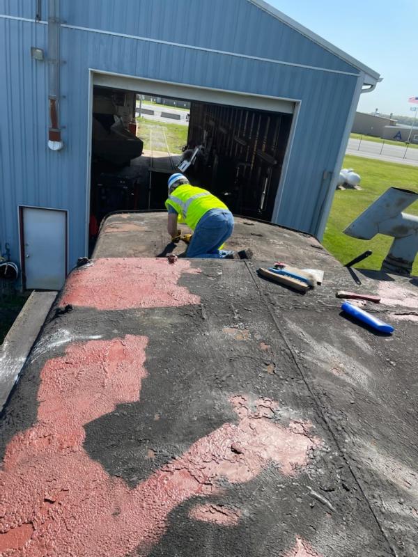 Association President Randy Voith gets down and dirty as he works on the roof of the caboose at its current home near Georgetown.