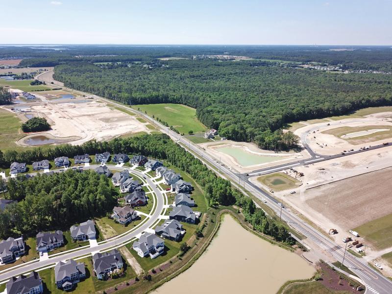 The Coral Lakes subdivision is planned for the wooded parcel remaining along Robinsonville Road. Already under construction are Chase Oaks, top left, Tidewater Landing, below left, and Tanager Woods, right. NICK ROTH PHOTO