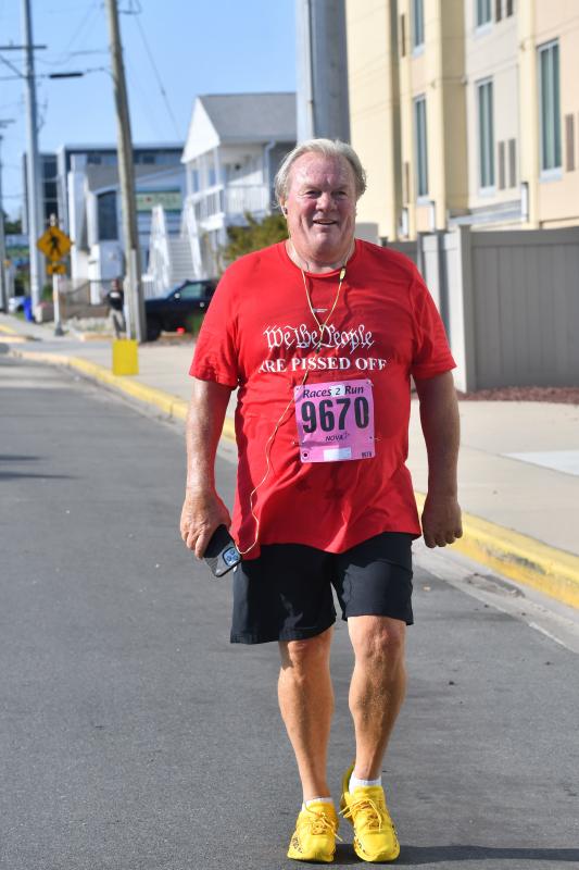 Tom Jones, an avid Eagles fan, walks the Highway One Companies 5K.