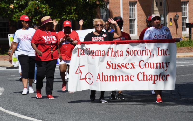 Members of Delta Sigma Theta Sorority, Sussex Chapter, are decked out in red and white.