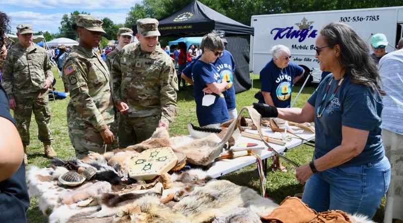 Nanticoke Tribe member Melissa Anderson, far right, explains the history and meaning of natural displays provided by the Nanticokes.