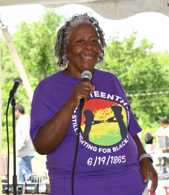 The Rev. Tambra Stewart, chair of the Juneteenth celebration committee, welcomes everyone to the event on the grounds of the Richard Allen School in Georgetown.