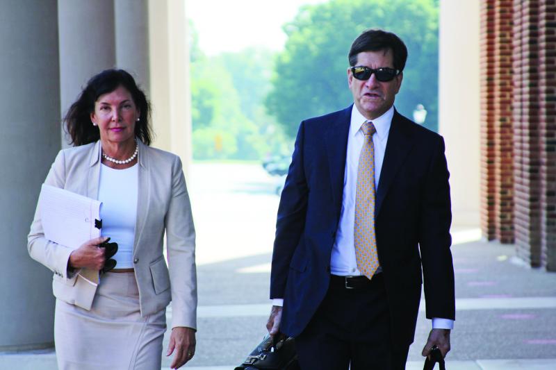 State Auditor Kathy McGuiness walks to Kent County Superior Court with her attorney Steve Wood. MELISSA STEELE PHOTO