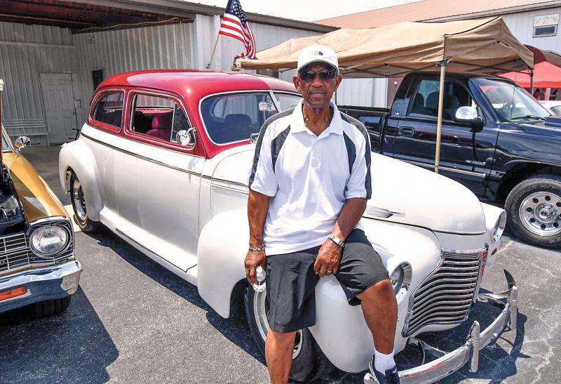 Pastor Arthur Jones of Trinity Faith Christian Center relaxes on his 1941 Chevy Coupe.