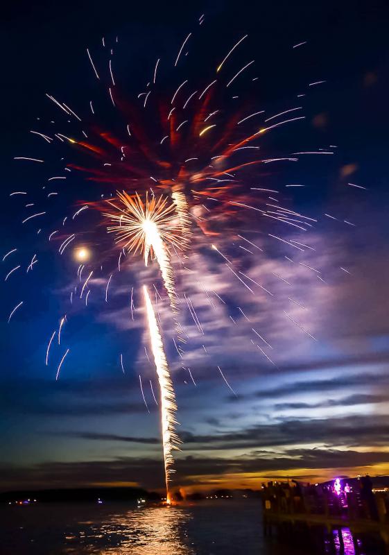 The moon sneaks into the fireworks display.