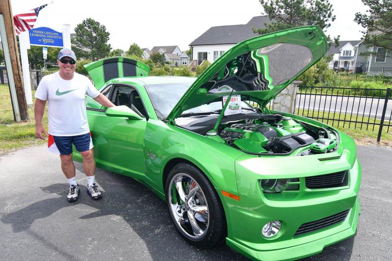John Morris stands with his tricked-out 2011 Chevy Camaro.