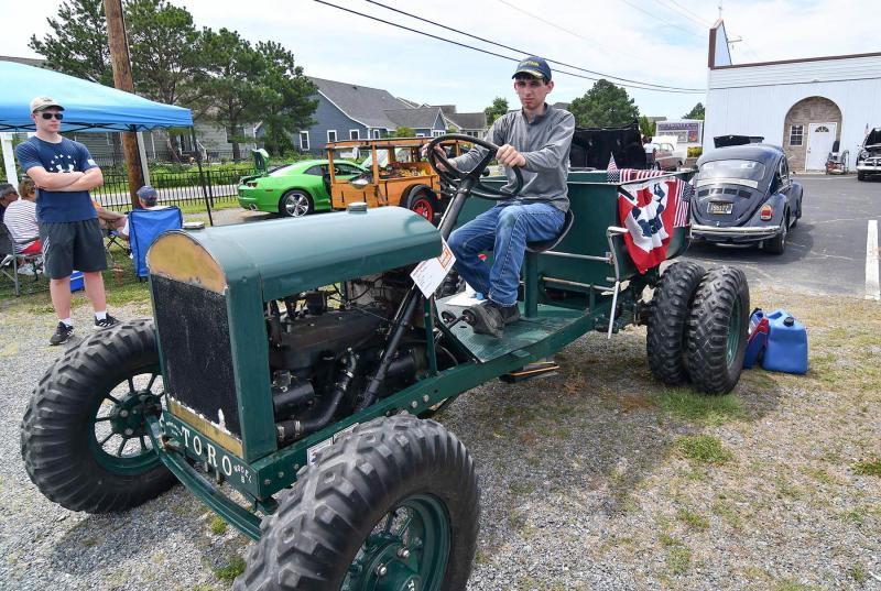 Quinn Stoops rides his 1935 Toro tractor.